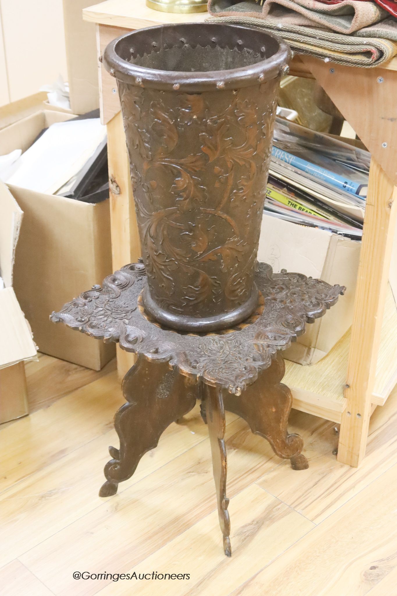 A 19th century carved side table and an Arts and Crafts stamped leather stick stand, height 45cm